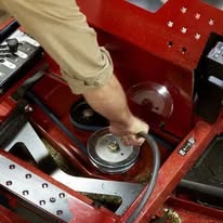 Service technician working on a Toro mower deck